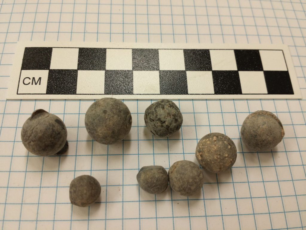 Lead balls of various sizes with a photo scale.