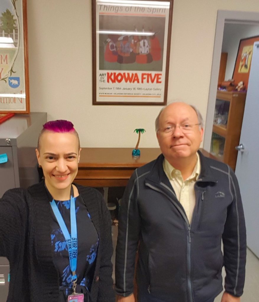 Selfie of the author and her employer, standing in the lab, smiling.