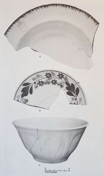 Black-and-white photo scanned from excavation report. It shows two large plate sherds and one reassembled bowl. One plate has a feathered edge decoration, the other has a painted floral motif. The bowl is white with a relief decoration on the outside.