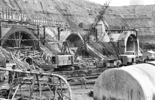 Black and white photo of construction site with a lot of scaffolding.