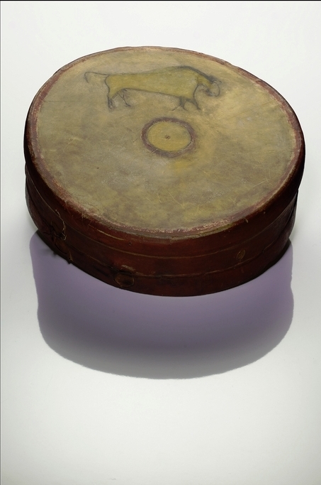 Color photo of a drum. The drumming surface has a drawing of a bison and a sun design in the center.