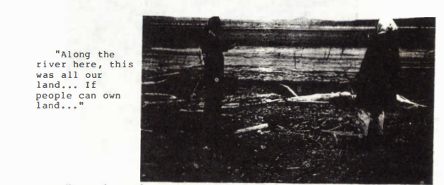 Scan of page from report with very dark photo of two people standing on a riverbank. Typewritten text next to image reads: "Along the river here, this was all our land... If people can own land..."